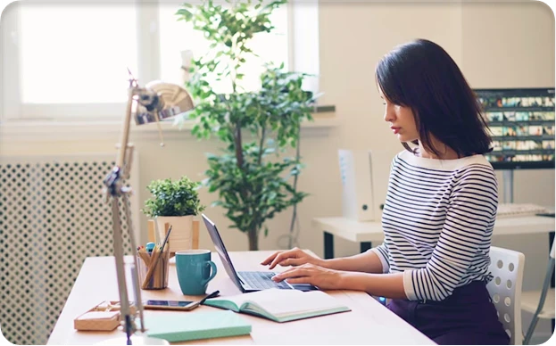A marketer analysing customer data on a laptop